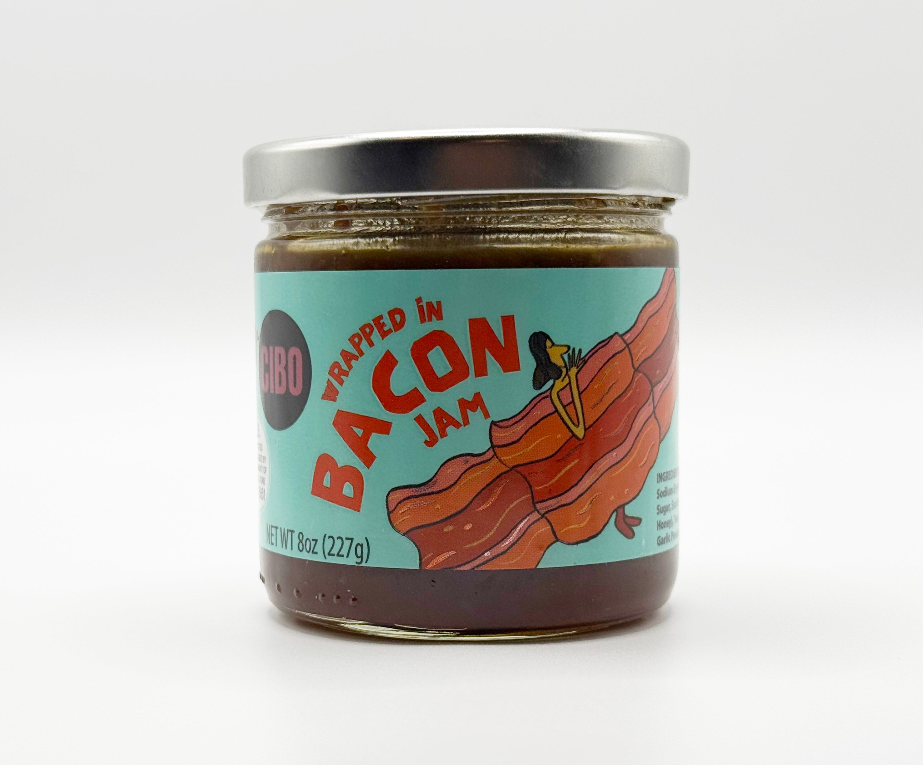 Jar of 'Wrapped in Bacon Jam' with a colorful label on a white background
